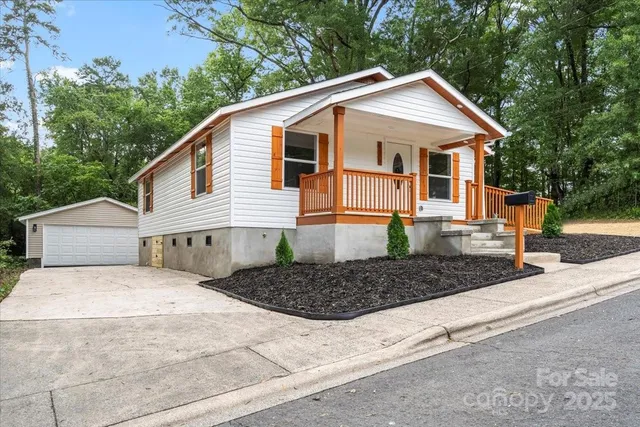 a front view of a house with trees