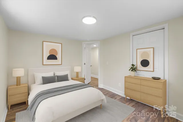 a bedroom with a bed and a lamp on dresser