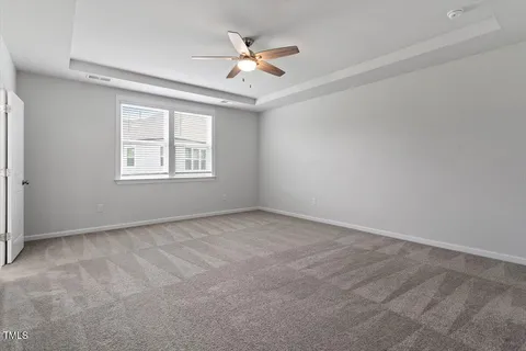 a spacious bedroom with a bed and a large window