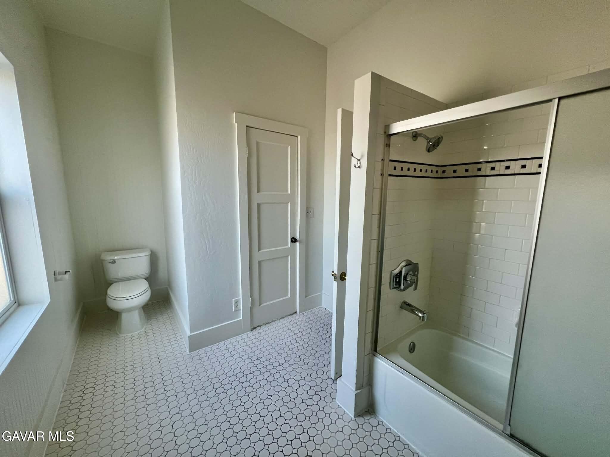 2702 19th Street Bakersfield, CA 93301 - Photo 9 of 21 a bathroom with a granite countertop sink a toilet and shower