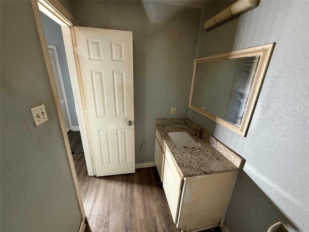 2009 Apache Road Quinlan, TX 75474 - Photo 18 of 19 a bathroom with a granite countertop sink and a mirror