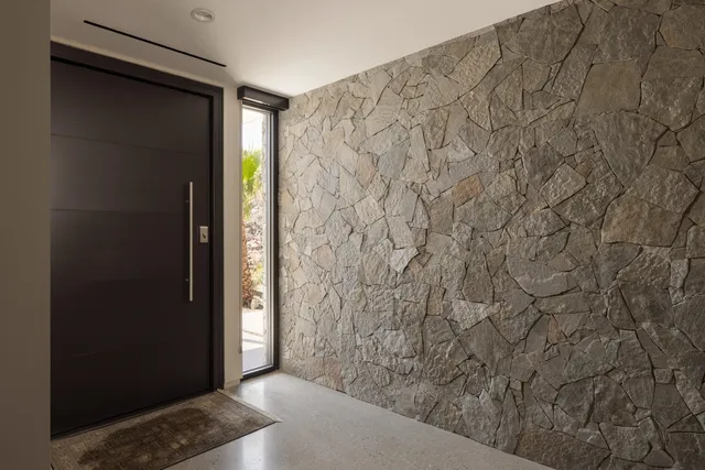 a bedroom with a bed and a lamp next to a window