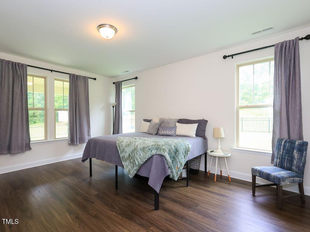 110 Point View Way Franklinton, NC 27525 - Photo 32 of 62 a spacious bedroom with a bed and wooden floor