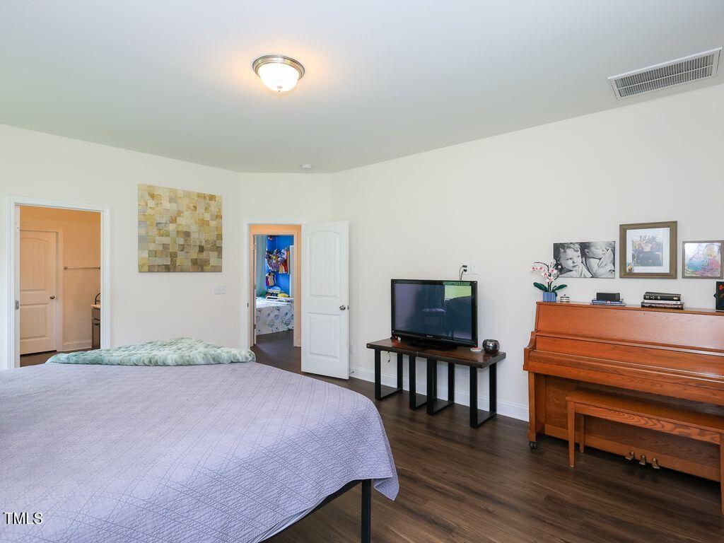 110 Point View Way Franklinton, NC 27525 - Photo 34 of 62 a bedroom with a bed and wooden floor