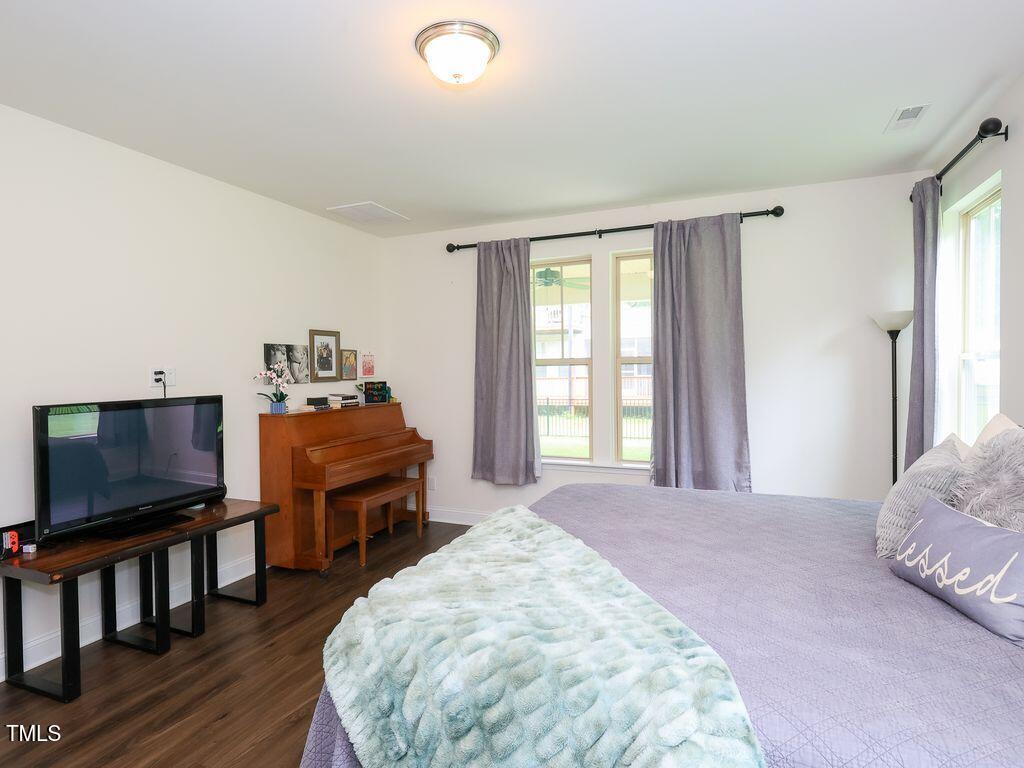 110 Point View Way Franklinton, NC 27525 - Photo 35 of 62 a spacious bedroom with a bed and a flat screen tv