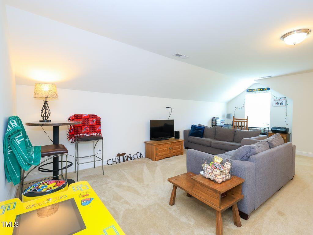 110 Point View Way Franklinton, NC 27525 - Photo 53 of 62 a living room with furniture and a flat screen tv with kitchen view