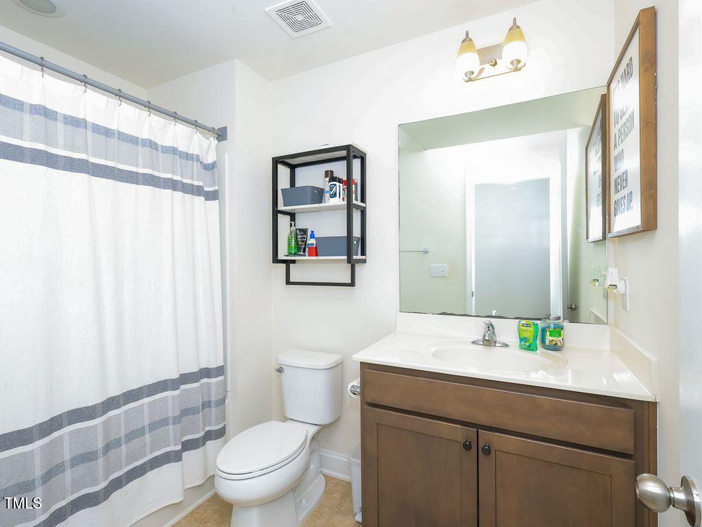 110 Point View Way Franklinton, NC 27525 - Photo 57 of 62 a bathroom with a toilet sink and mirror