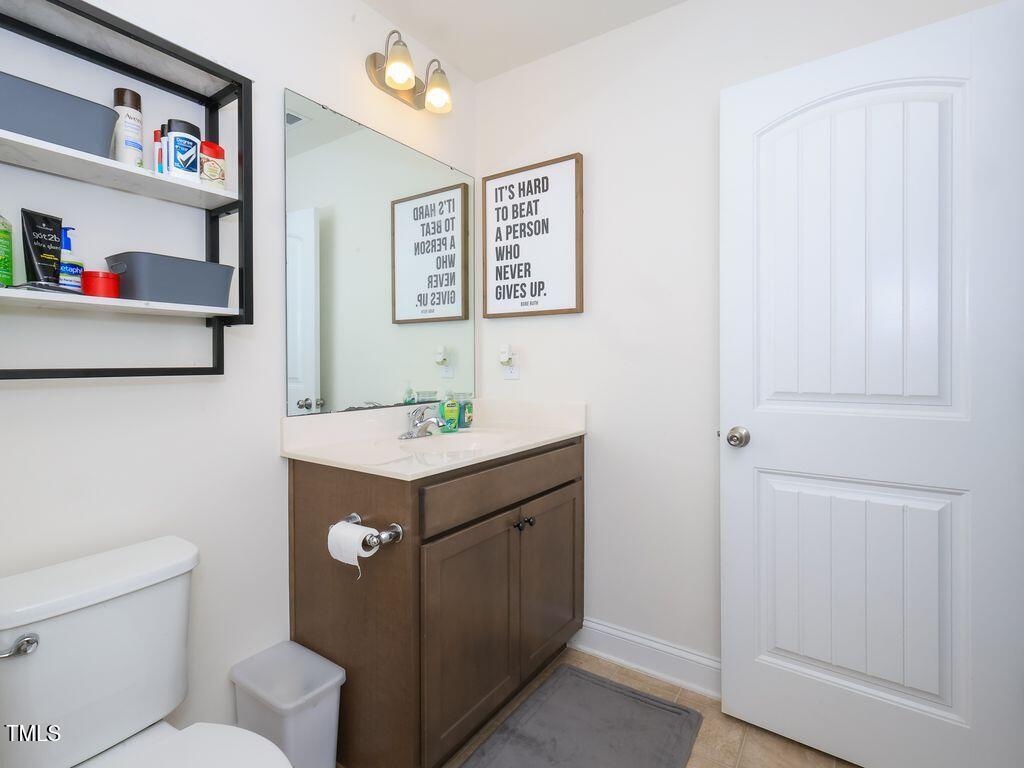 110 Point View Way Franklinton, NC 27525 - Photo 58 of 62 a bathroom with a sink mirror vanity and toilet