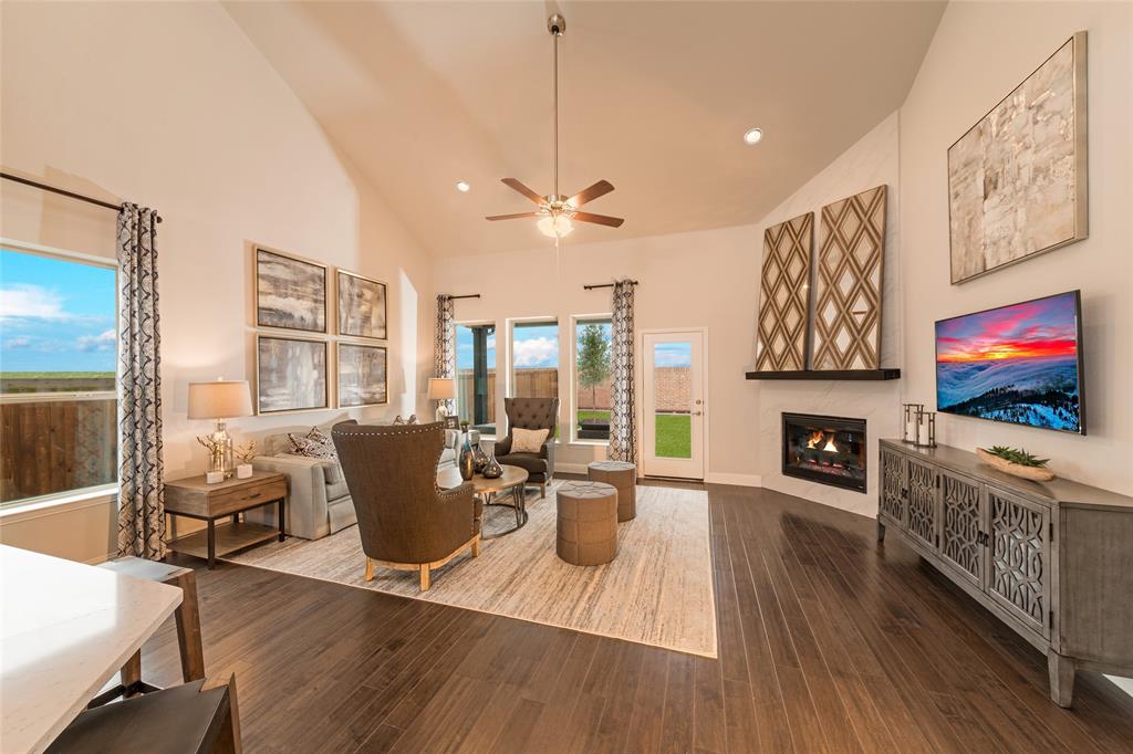 112 Capital Court Forney, TX 75126 - Photo 7 of 13 a living room with furniture flat screen tv and wooden floor