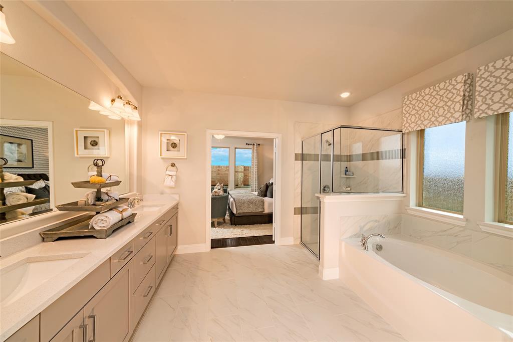 112 Capital Court Forney, TX 75126 - Photo 9 of 13 a spacious en suite bathroom with a tub sink and view bedroom