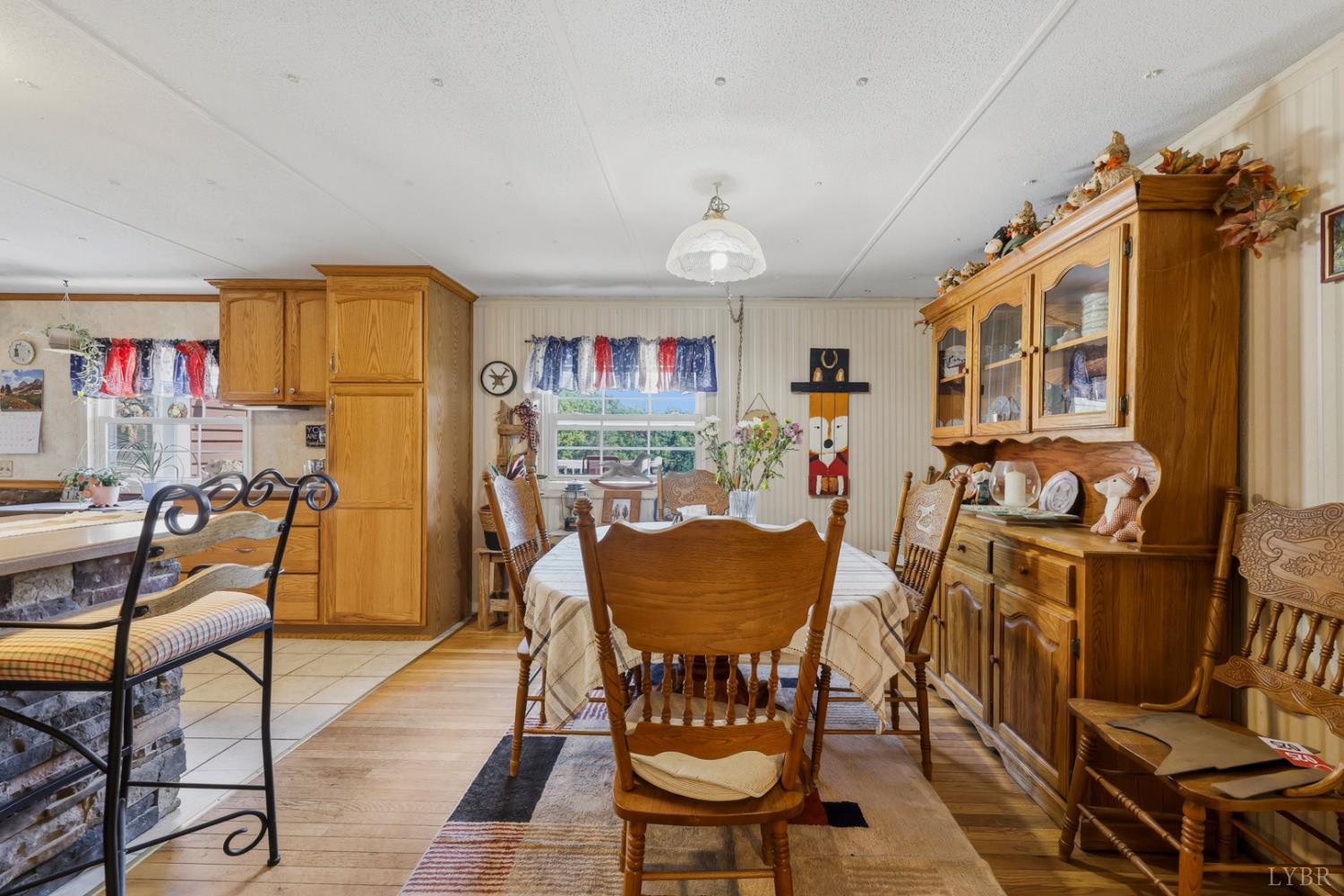 809 Plantation Road Amherst, VA 24521 - Photo 17 of 77 a view of a dining room with furniture a chandelier and wooden floor