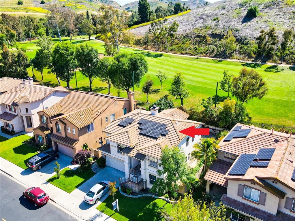 an aerial view of multiple houses with yard
