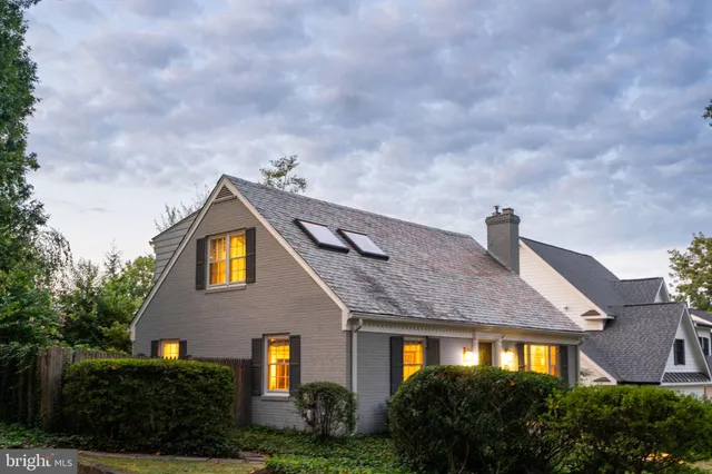 a front view of a house with lots of green space