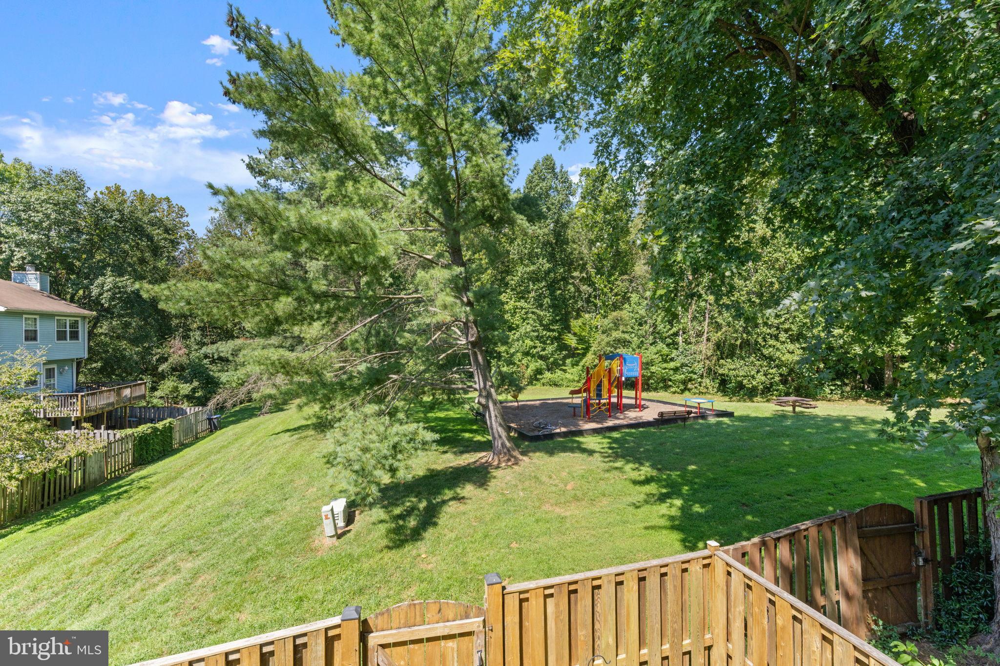 5128 Spring Branch Boulevard Dumfries, VA 22025 - Photo 21 of 60 View of the fenced in yard, green space & tot lot.