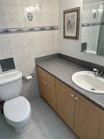 a white toilet sitting next to a shower