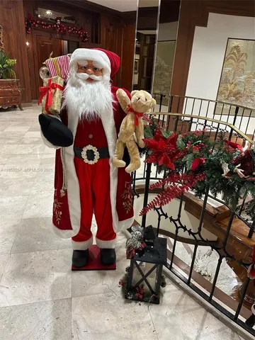 a kitchen with stainless steel appliances granite countertop a sink a stove a refrigerator a washer dryer and white cabinets