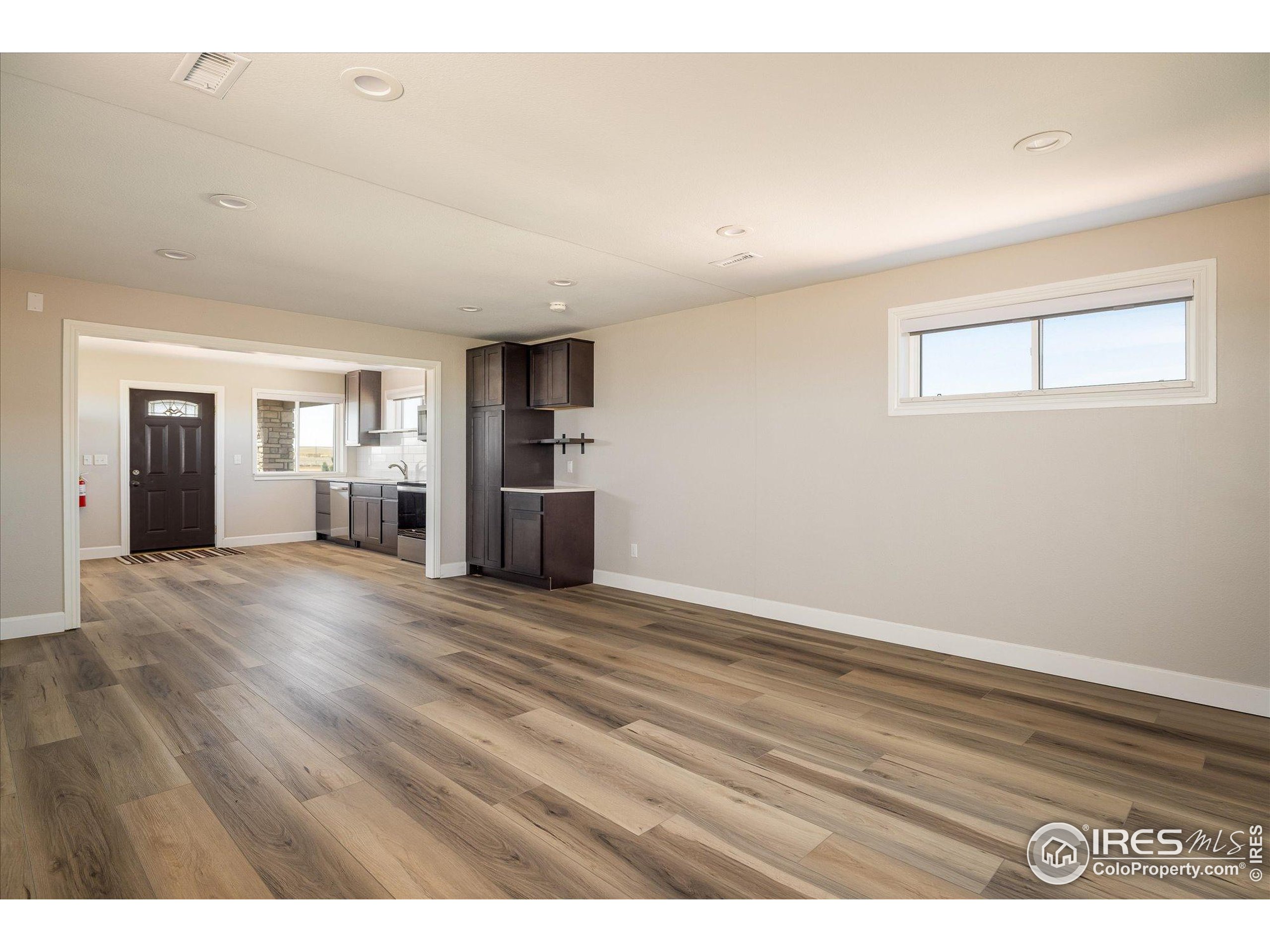13400 Harvest Road Commerce City, CO 80022 - Photo 32 of 50 a view of empty room with wooden floor