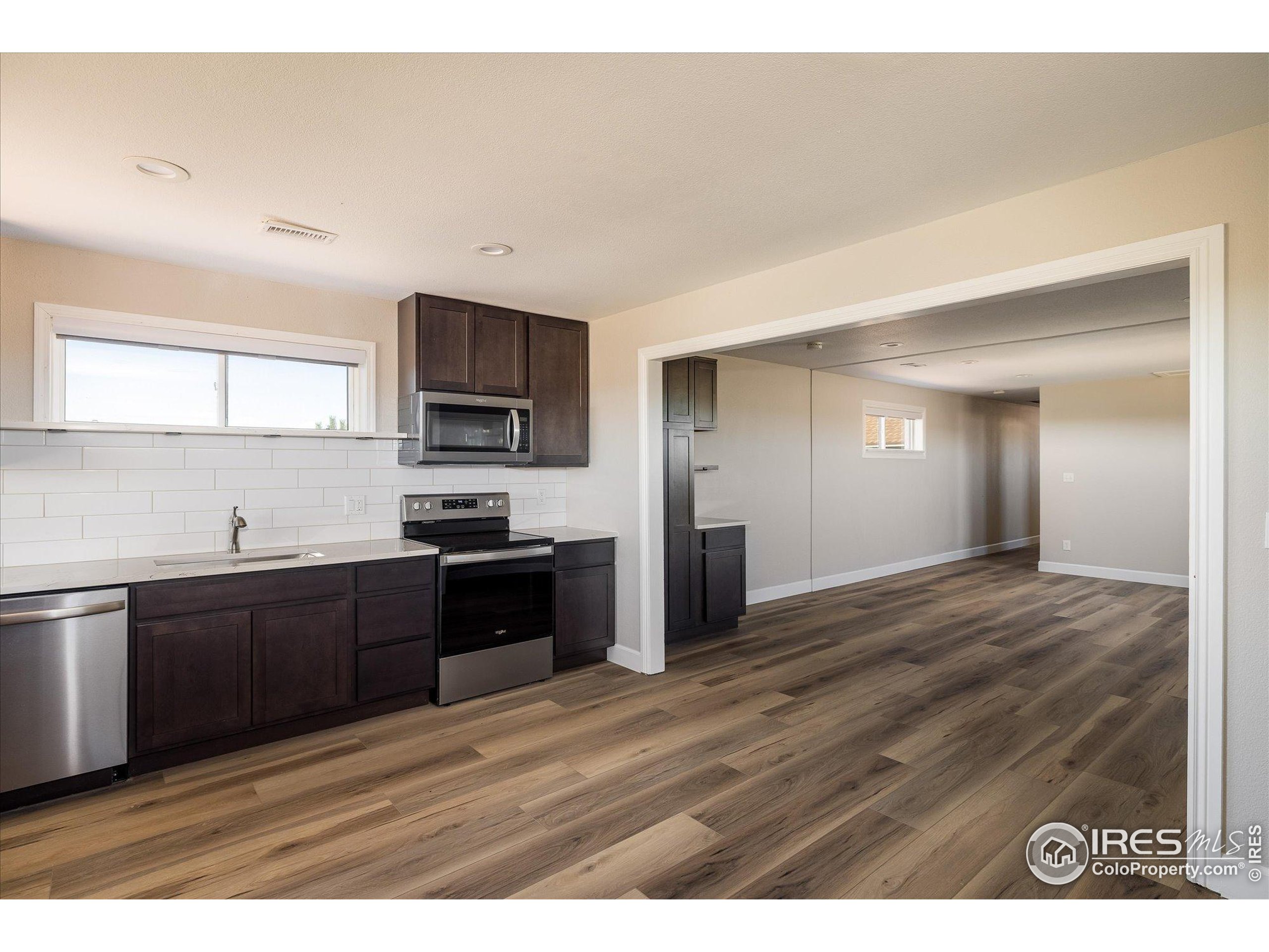 13400 Harvest Road Commerce City, CO 80022 - Photo 36 of 50 a kitchen with granite countertop a stove top oven and sink