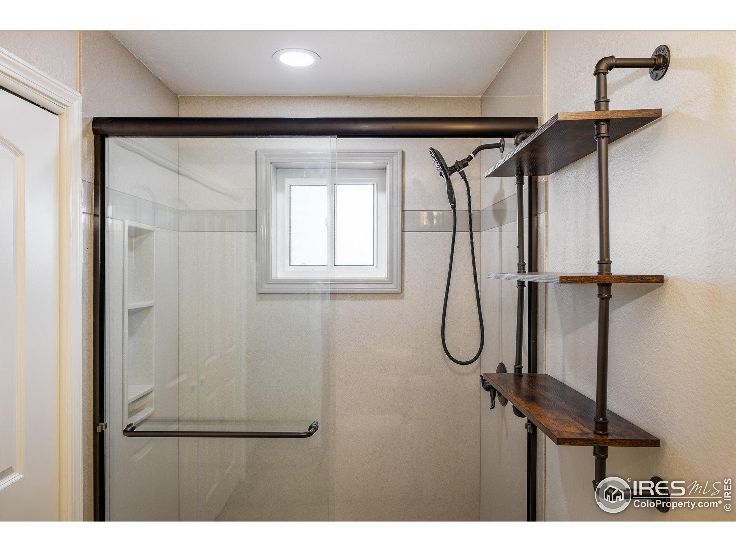 13400 Harvest Road Commerce City, CO 80022 - Photo 38 of 50 a bathroom with a glass shower door