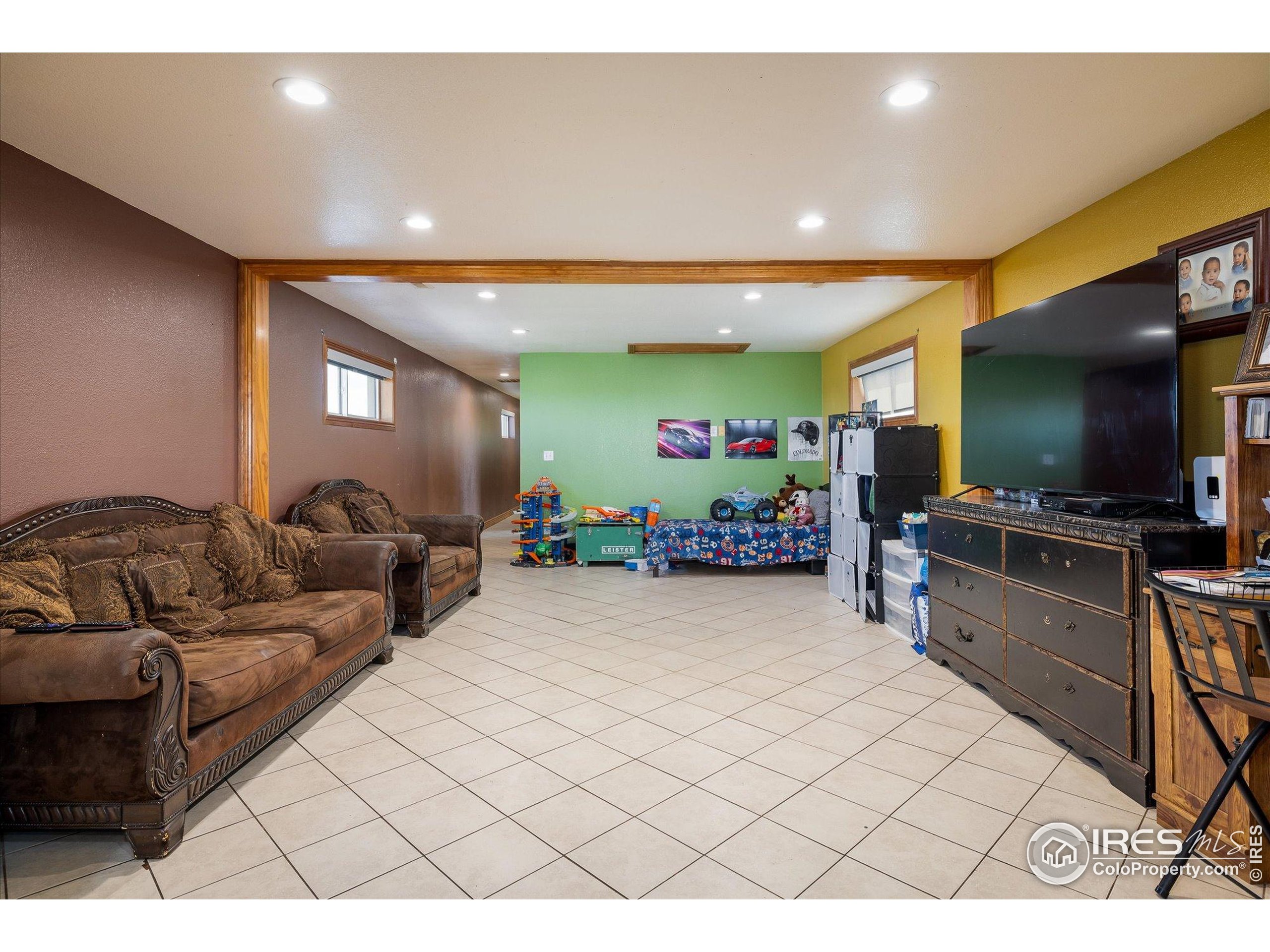 13400 Harvest Road Commerce City, CO 80022 - Photo 44 of 50 a living room with furniture and a flat screen tv