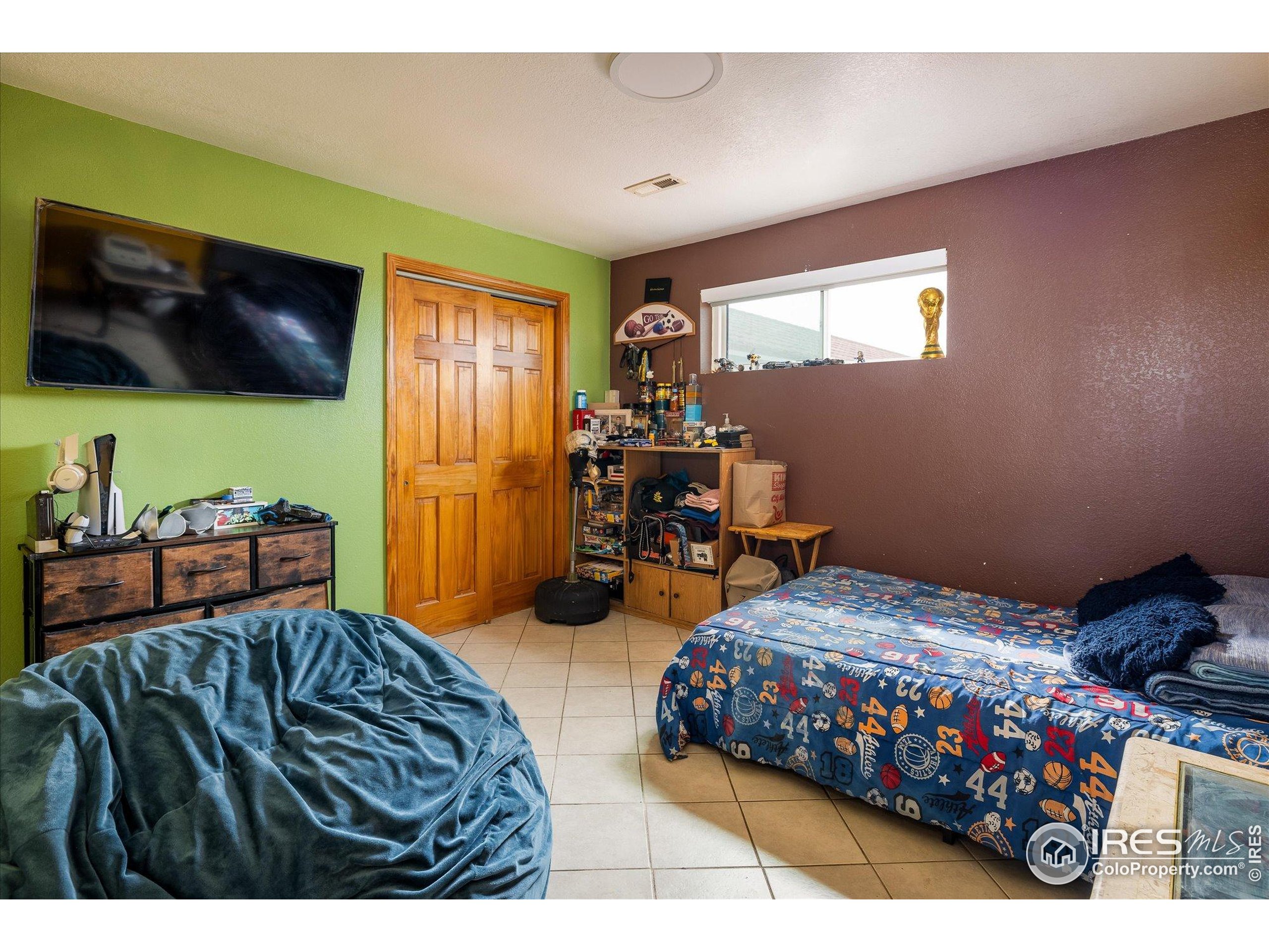 13400 Harvest Road Commerce City, CO 80022 - Photo 49 of 50 a bedroom with furniture and a flat screen tv