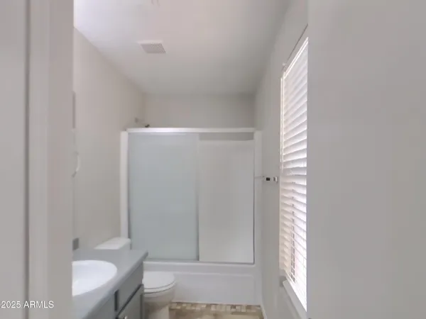 an empty room with windows and entrance