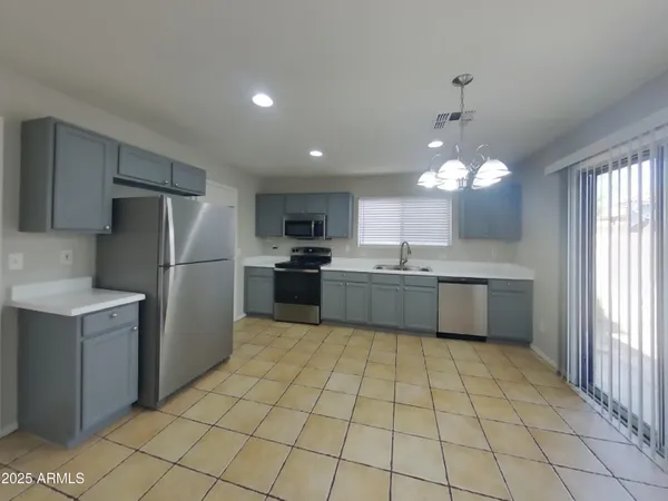 a view of kitchen and kitchen with furniture large window