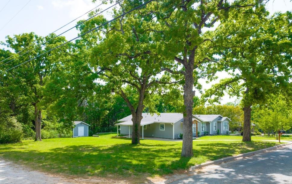 Nestled in the arms of towering live oaks, this home feels like "country."