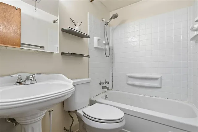 a bathroom with a sink toilet and bathtub