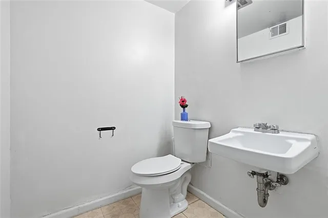 a bathroom with a sink toilet and a mirror