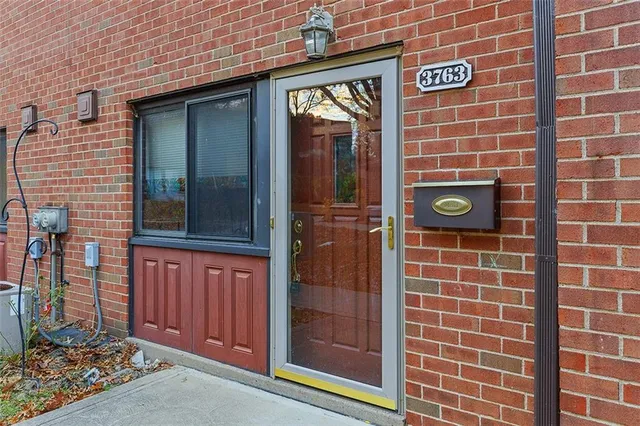 a brick building with a window and a door