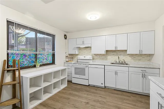 a kitchen with stainless steel appliances granite countertop a stove and cabinets