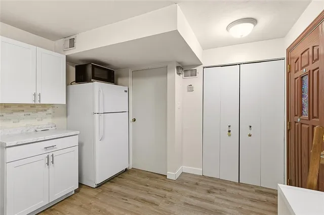 a view of cabinets with wooden floor