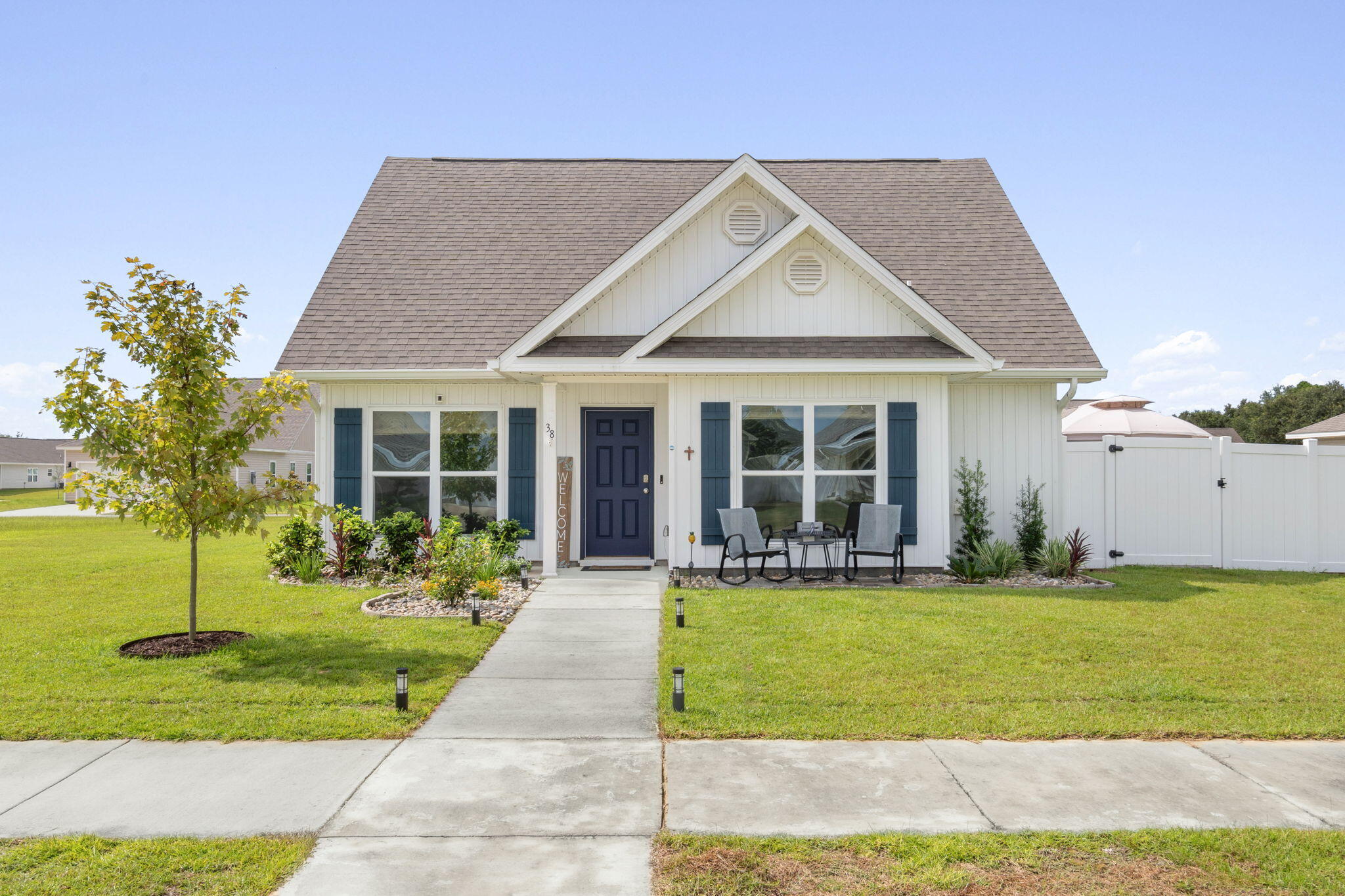 a front view of a house with a yard and porch