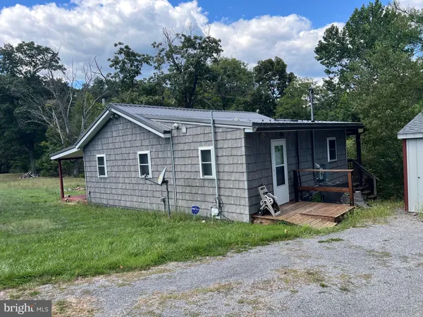 a view of a house with a yard and fence