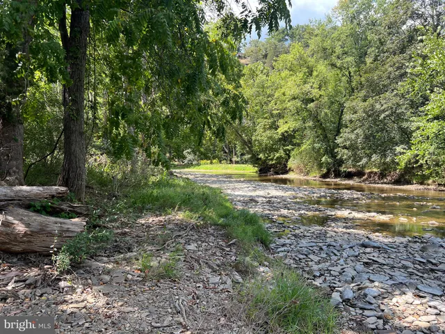 a view of dirt road with a building