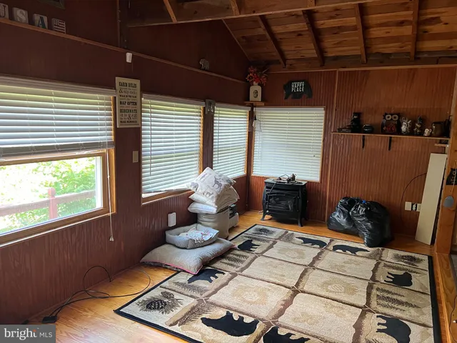 a view of a livingroom with wooden floor and windows