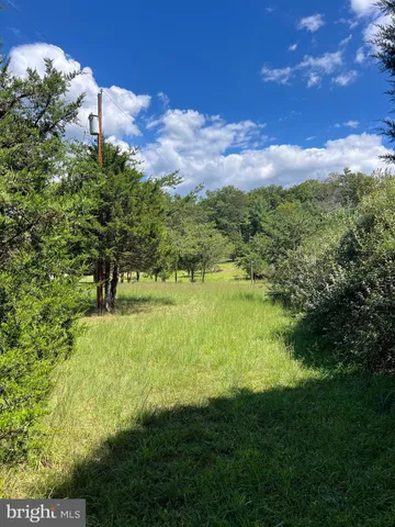 a view of balcony with wooden floor and outdoor seating