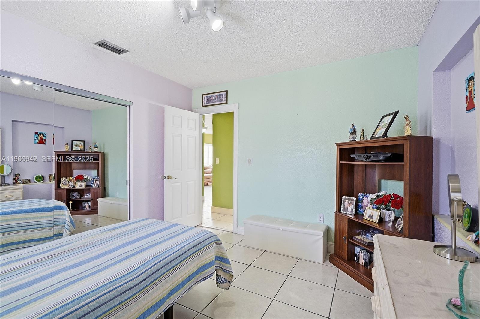 4791 West 3rd Avenue Hialeah, FL 33012 - Photo 12 of 30 a bed room with a bed and a window