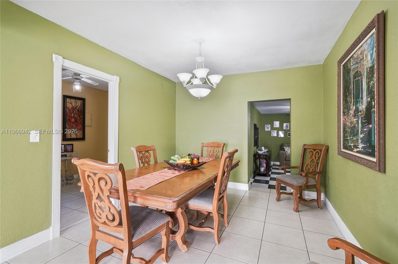 4791 West 3rd Avenue Hialeah, FL 33012 - Photo 13 of 30 a dining room with furniture and a chandelier