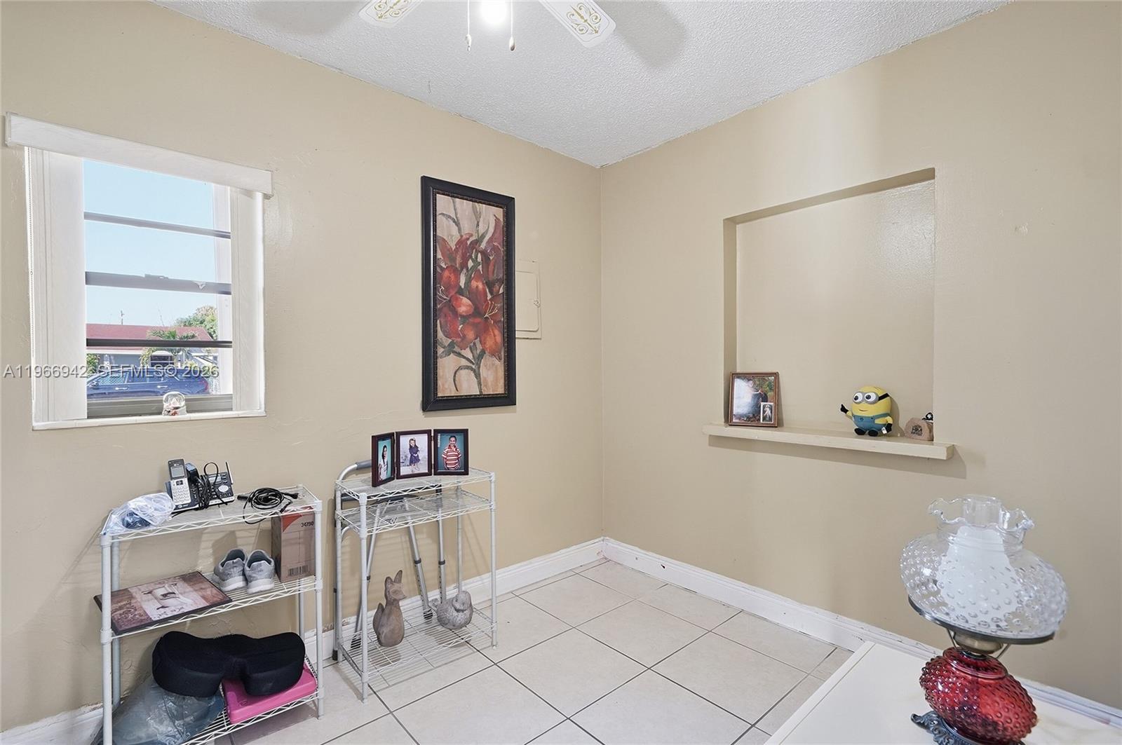 4791 West 3rd Avenue Hialeah, FL 33012 - Photo 15 of 30 a bedroom with a bed and a window