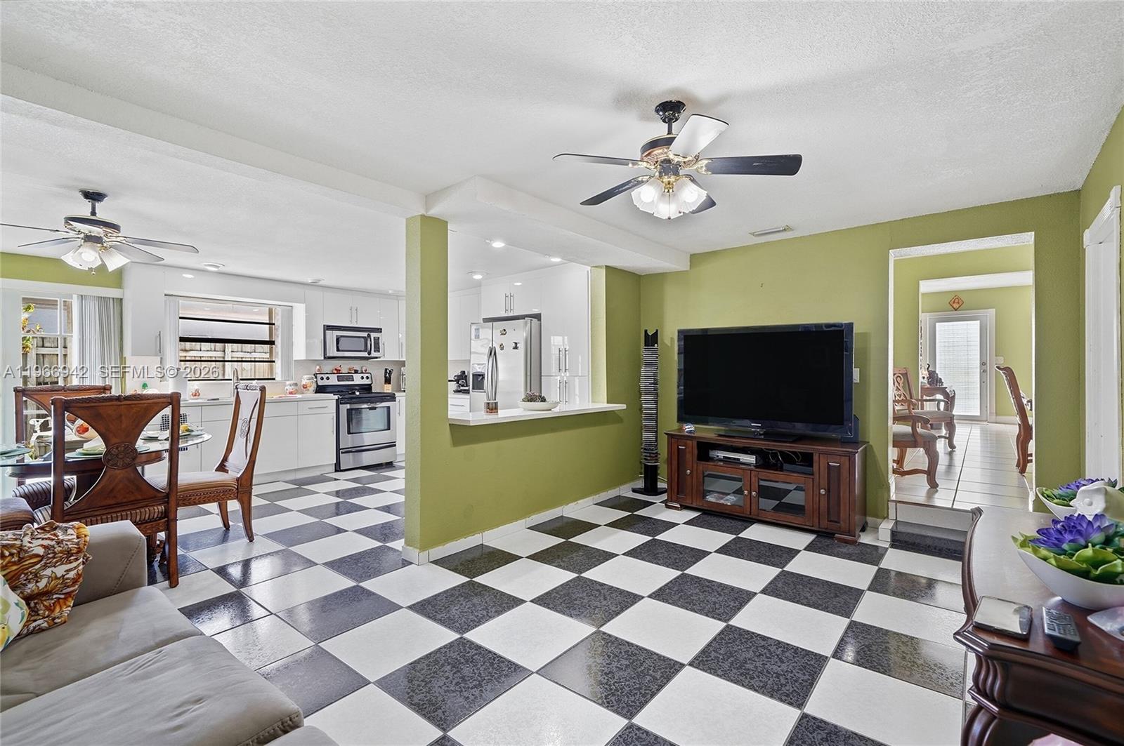 4791 West 3rd Avenue Hialeah, FL 33012 - Photo 17 of 30 a view of a livingroom with furniture and a flat screen tv