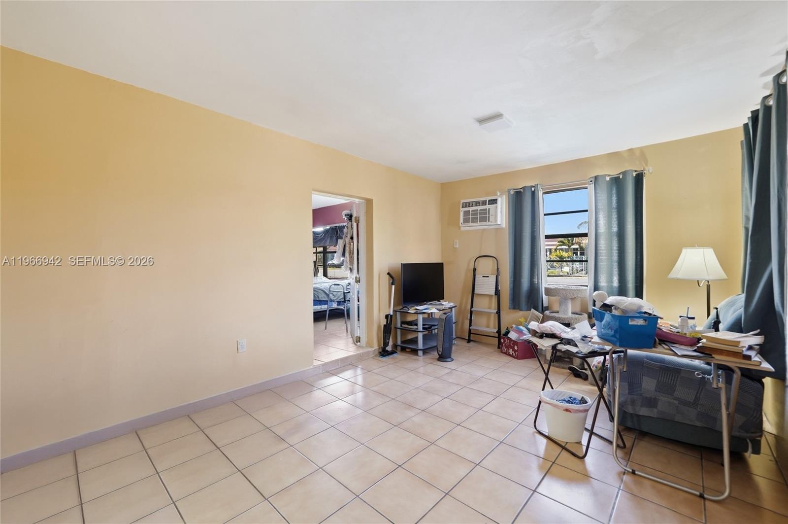 4791 West 3rd Avenue Hialeah, FL 33012 - Photo 21 of 30 a living room with furniture and a fireplace