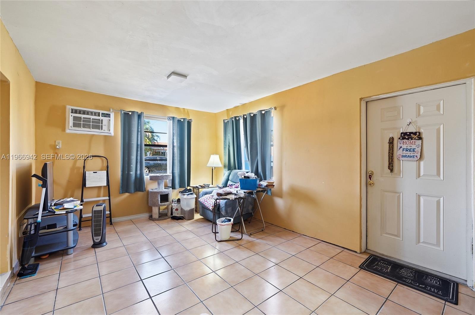 4791 West 3rd Avenue Hialeah, FL 33012 - Photo 22 of 30 a living room with furniture and large window
