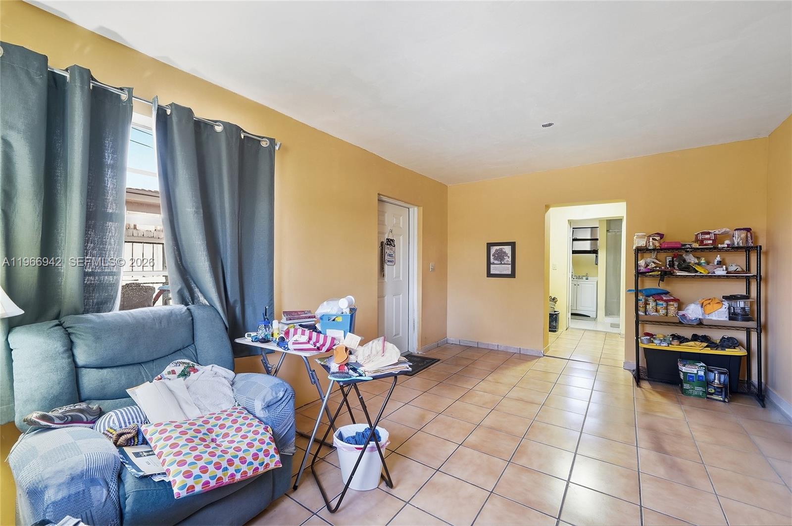 4791 West 3rd Avenue Hialeah, FL 33012 - Photo 23 of 30 a living room with furniture and a large window