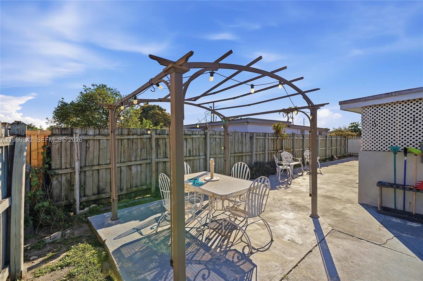 4791 West 3rd Avenue Hialeah, FL 33012 - Photo 28 of 30 a view of a patio with a dining table and chairs with wooden floor