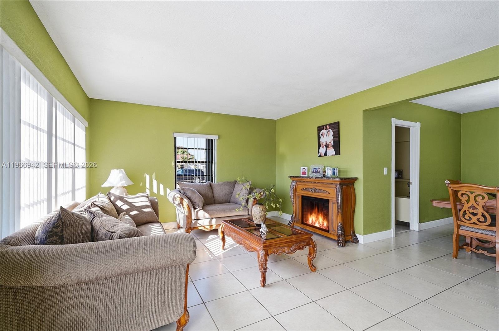 4791 West 3rd Avenue Hialeah, FL 33012 - Photo 5 of 30 a living room with furniture and a fireplace