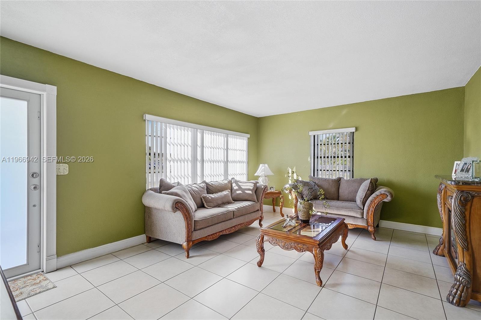 4791 West 3rd Avenue Hialeah, FL 33012 - Photo 6 of 30 a living room with furniture and a window