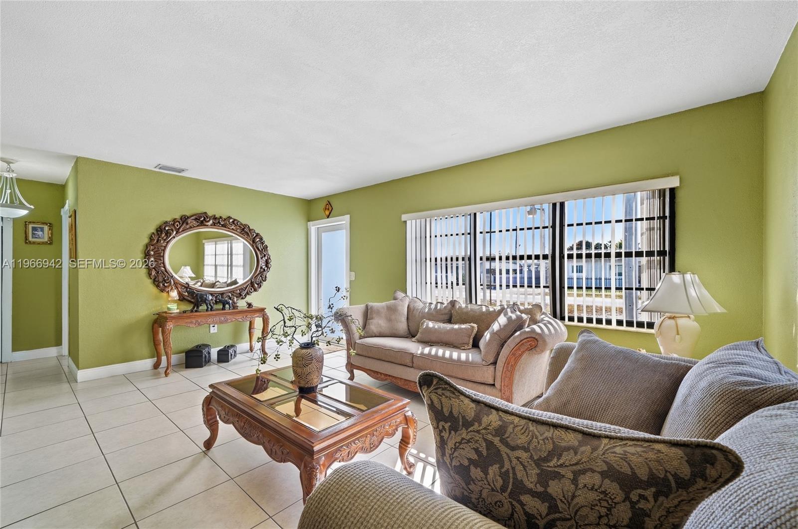 4791 West 3rd Avenue Hialeah, FL 33012 - Photo 7 of 30 a living room with furniture a rug and a window