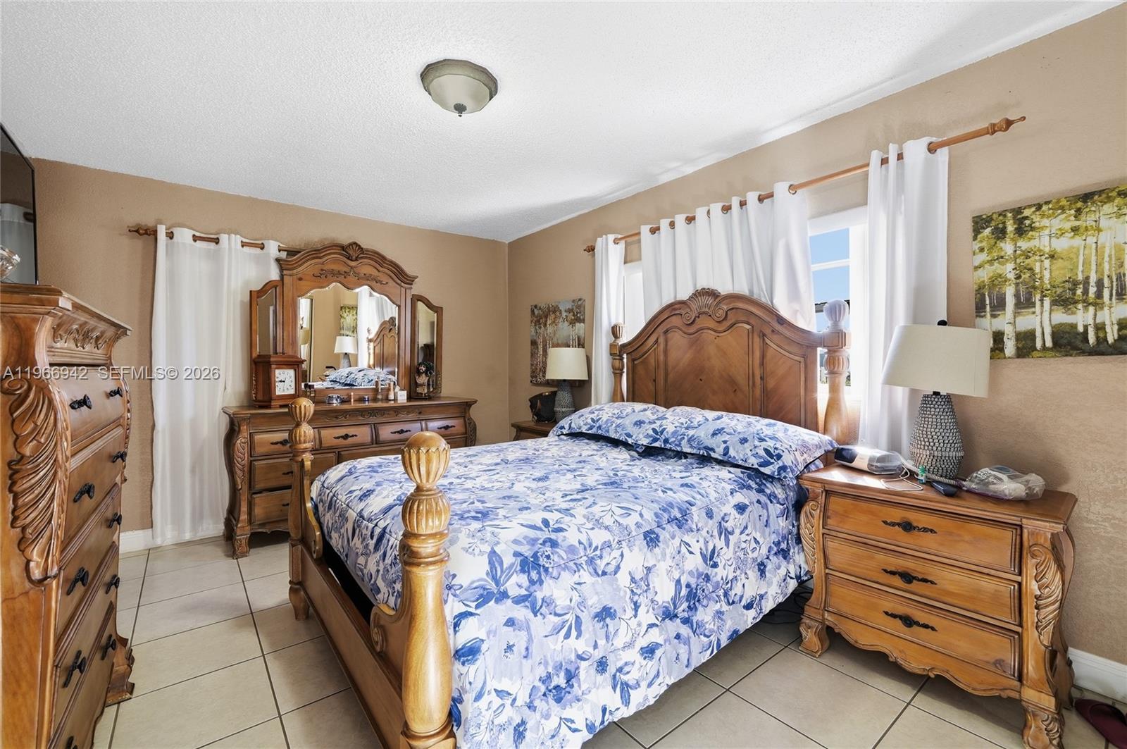 4791 West 3rd Avenue Hialeah, FL 33012 - Photo 8 of 30 a bedroom with a bed and a mirror on the dresser
